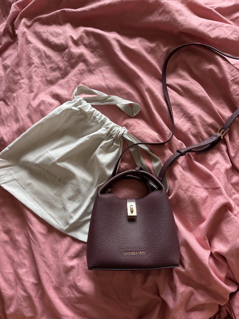 RUSH AUTHENTIC CHARLES & KEITH Mini Chance Turn-Lock Bucket Bag (Category: Cross-body Bags) located in Pasig City. Submitted by todaysarchives (Listing ID 1468758808, Image 1). Description: New with dust bag packaging included. 100% authentic, straight from the store in Singapore. Retails for P5,000, selling for P3,000. NEVER USED.