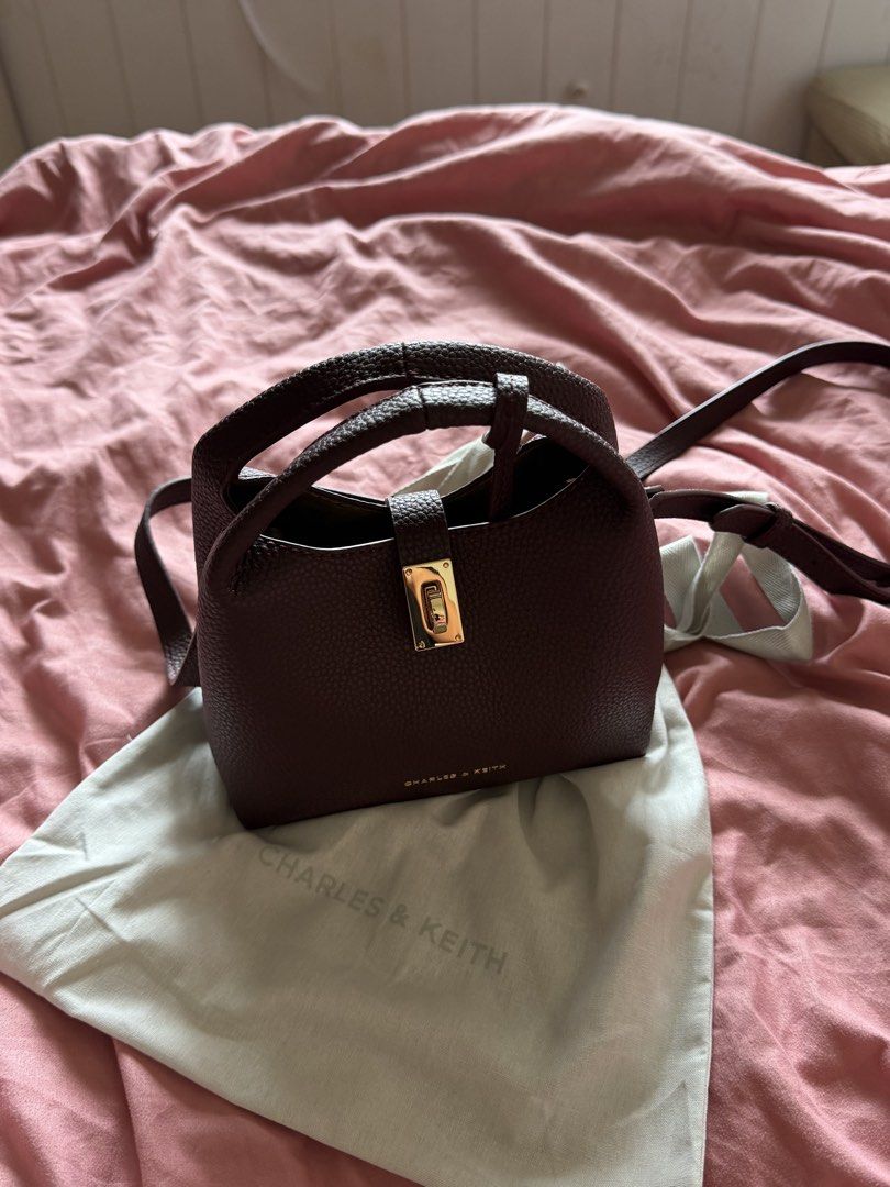 RUSH AUTHENTIC CHARLES & KEITH Mini Chance Turn-Lock Bucket Bag (Category: Cross-body Bags) located in Pasig City. Submitted by todaysarchives (Listing ID 1468758808, Image 3). Description: New with dust bag packaging included. 100% authentic, straight from the store in Singapore. Retails for P5,000, selling for P3,000. NEVER USED.