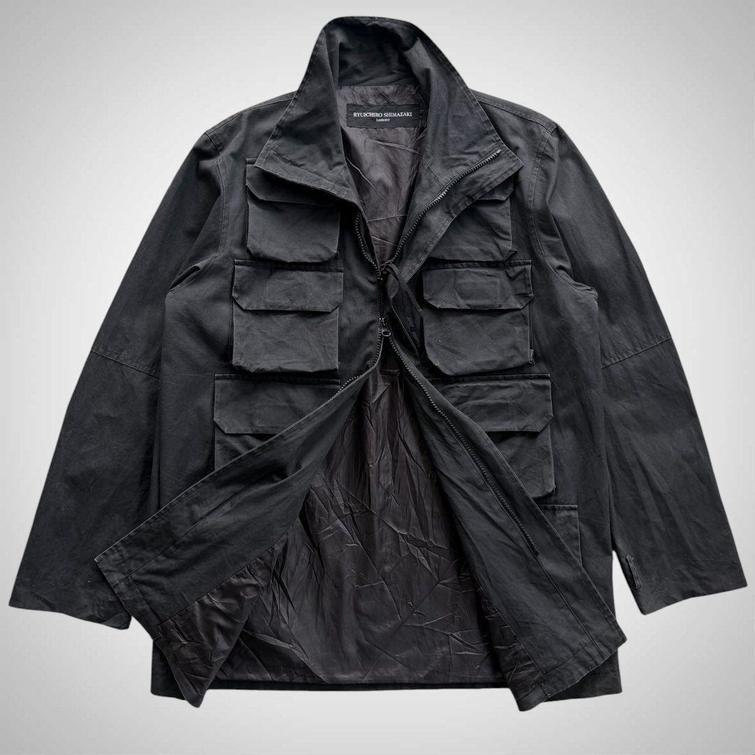 Ryuichiro Shimazaki Military Parasite Cargo Jacket (Category: Coats, Jackets and Outerwear) located in Zamboanga. Submitted by the.angura.store (Listing ID 1468722837, Image 2). Description: Ryuichiro Shimazaki Military Parasite Cargo Jacket 90’s Ryuichiro Shimazaki Parasite Field Cargo Jacket, features striking eight-pocket front grid with concealed front fastening, a high protective stand collar. 2-zipper closure that can be styled in multiple 