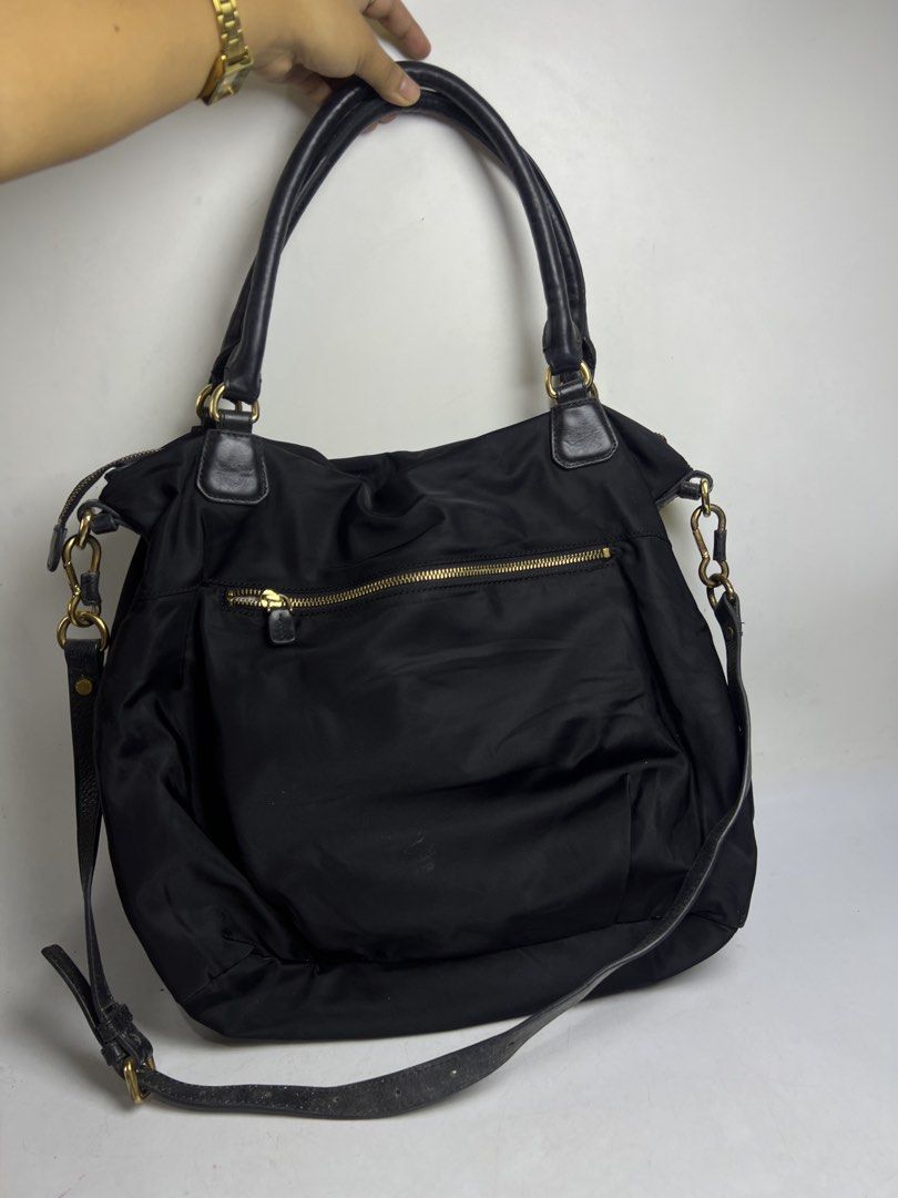 Salad Black Nylon Shoulder Bag with Strap (Category: Shoulder Bags) located in Baguio. Submitted by chiechie1234 (Listing ID 1468838225, Image 2). Description: - Brand: Salad - Material: Durable black nylon with chic gold hardware - Versatile Carry: Includes top handles and an adjustable crossbody strap - Storage: Exterior back zipper pocket and spacious slouchy interior - Interior Details: Stylish patterned fabric lining with a branded cloth tag