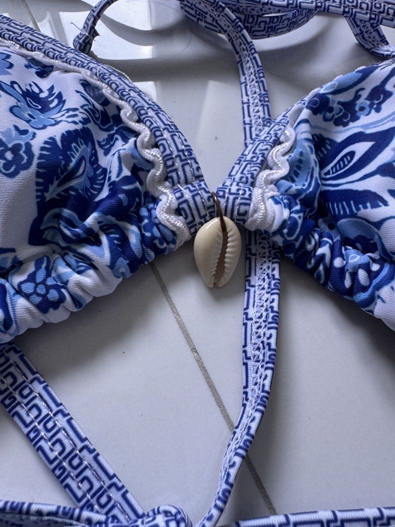 SALE! Get for ₱250 each (Category: Bikinis & Swimsuits) located in Quezon City. Submitted by poshforward (Listing ID 1468741633, Image 2). Description: - Style: Blue and white floral print bikini set - Size: XS - Condition: Brand new, unworn - Top: Halter neck with adjustable ties and cute seashell charm - Bottom: Adjustable side ties for a custom fit - Ideal for: Beach days, pool parties, and vacations.
