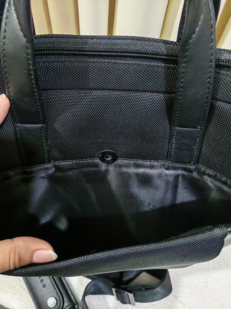Samsonite RED black briefcase laptop bag (Category: Briefcases) located in Makati City. Submitted by prelovedtreatedwithlove (Listing ID 1468880925, Image 3). Description: - Brand: Samsonite RED - Color: Black - Material: Durable nylon canvas and faux leather - Carry options: Dual top handles and detachable shoulder strap - Laptop protection: Padded interior sleeve with security strap - Storage: Multiple internal compartments and front magnetic p