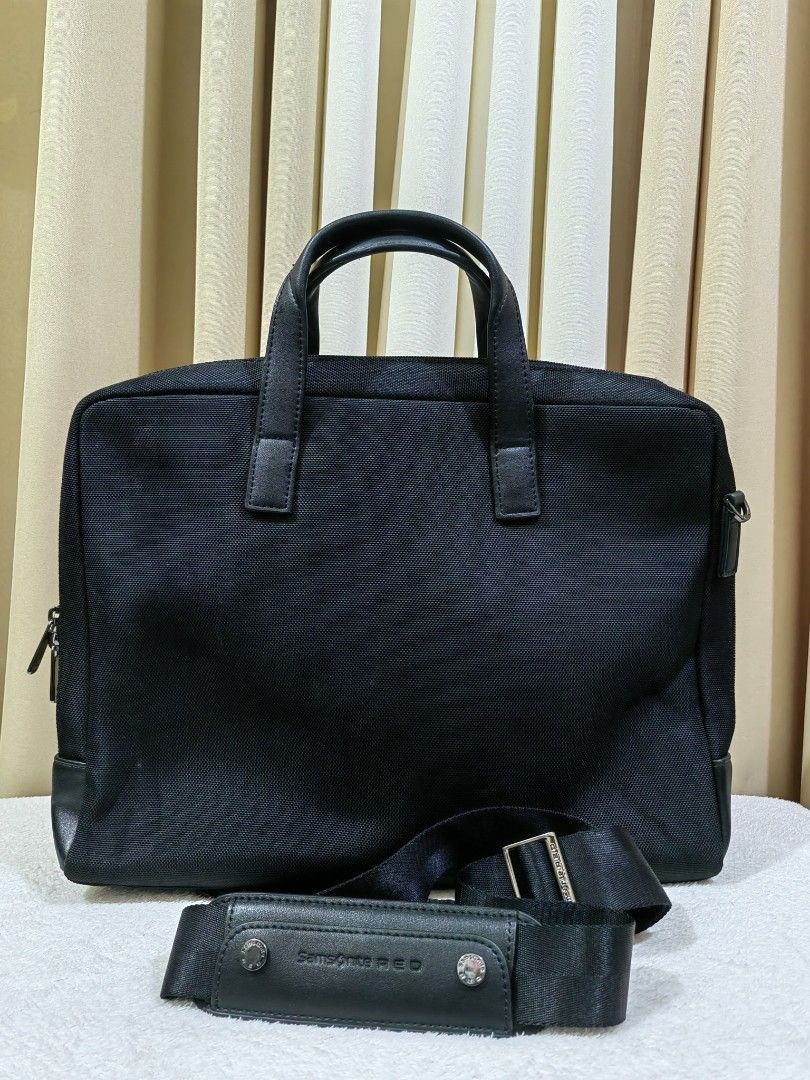 Samsonite RED black briefcase laptop bag (Category: Briefcases) located in Makati City. Submitted by prelovedtreatedwithlove (Listing ID 1468880925, Image 2). Description: - Brand: Samsonite RED - Color: Black - Material: Durable nylon canvas and faux leather - Carry options: Dual top handles and detachable shoulder strap - Laptop protection: Padded interior sleeve with security strap - Storage: Multiple internal compartments and front magnetic p