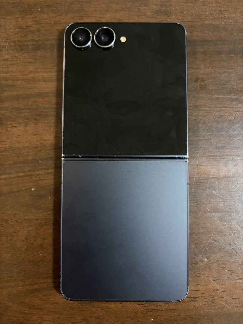 Samsung Flip 7 (Category: Samsung) located in Pasay City. Submitted by rdlf16 (Listing ID 1468926812, Image 2). Description: - Brand/Model: Samsung Flip 7 - Type: Foldable Smartphone - Color: Dark Grey / Black finish - Condition: Good working condition with major cosmetic wear/scuffs on the outer edges - Features: Dual rear cameras, vibrant main display, compact foldable design - Meetup Locations: SM City Santa Rosa, Pavillion Mall Biñan, Robinso