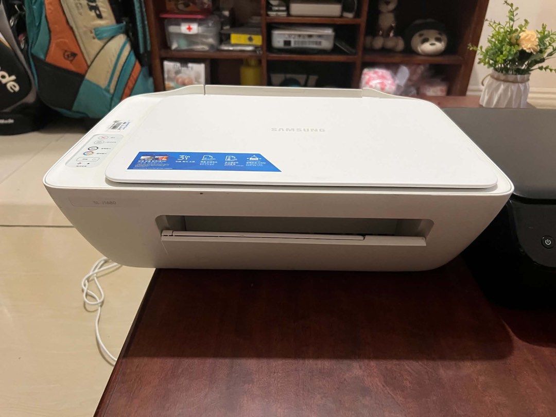 Samsung SL-J1680 All-in-One Printer (Category: Printers, Scanners & Copiers) located in Taguig. Submitted by ghiebow06 (Listing ID 1468785045, Image 1). Description: - Model: Samsung SL-J1680 Printer and Scanner Unit - Color: Clean white body - Design: Compact footprint that fits easily on any desk - Features: Flatbed scanner with a fully opening lid and front-folding paper tray - Controls: Standard, user-friendly control panel buttons located on