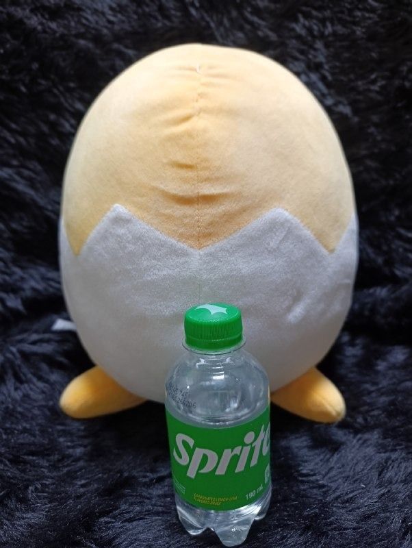 Sanrio Gudetama Egg Shell Plush Toy (Category: Plushies & Soft Toys) located in Iloilo. Submitted by jpk_ok_sales (Listing ID 1468798653, Image 2). Description: - Authentic Sanrio Gudetama plush toy featuring the lazy egg inside a cracked white eggshell - Features detailed embroidered facial expression on top - Made with ultra-soft, huggable plush material - Size reference: Shown next to a 190ml Sprite bottle (bottle not included) - Condition: Cl
