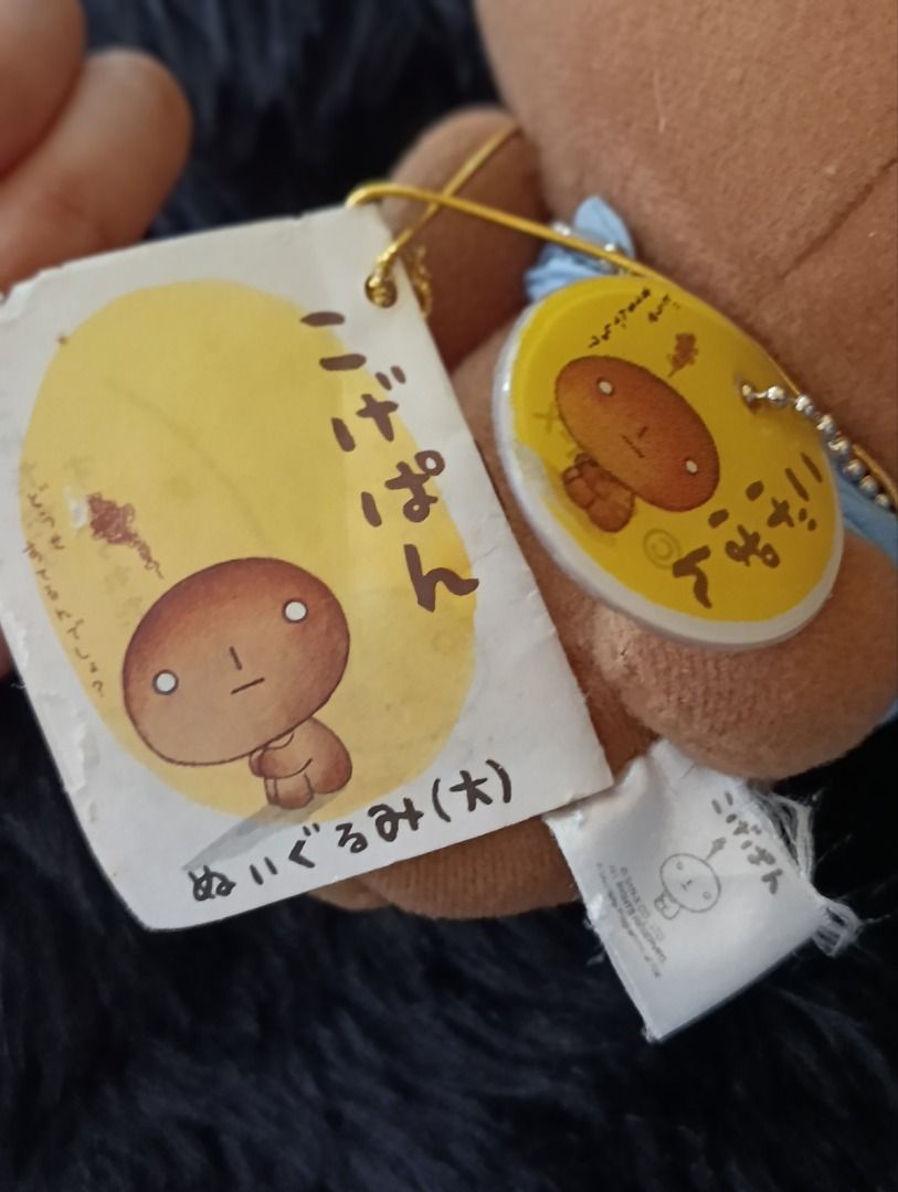 San-X Kogepan Plush Toy with Tags (Category: Plushies & Soft Toys) located in Iloilo. Submitted by jpk_ok_sales (Listing ID 1468802820, Image 2). Description: - 100% Authentic San-X Kogepan plush toy - Features a cute light blue backpack and gold ball chain - Original paper tags and authenticity sticker still attached - Medium-to-large size (taller than a standard drink bottle) - Must-have collectible for Sanrio and Kogepan fans.