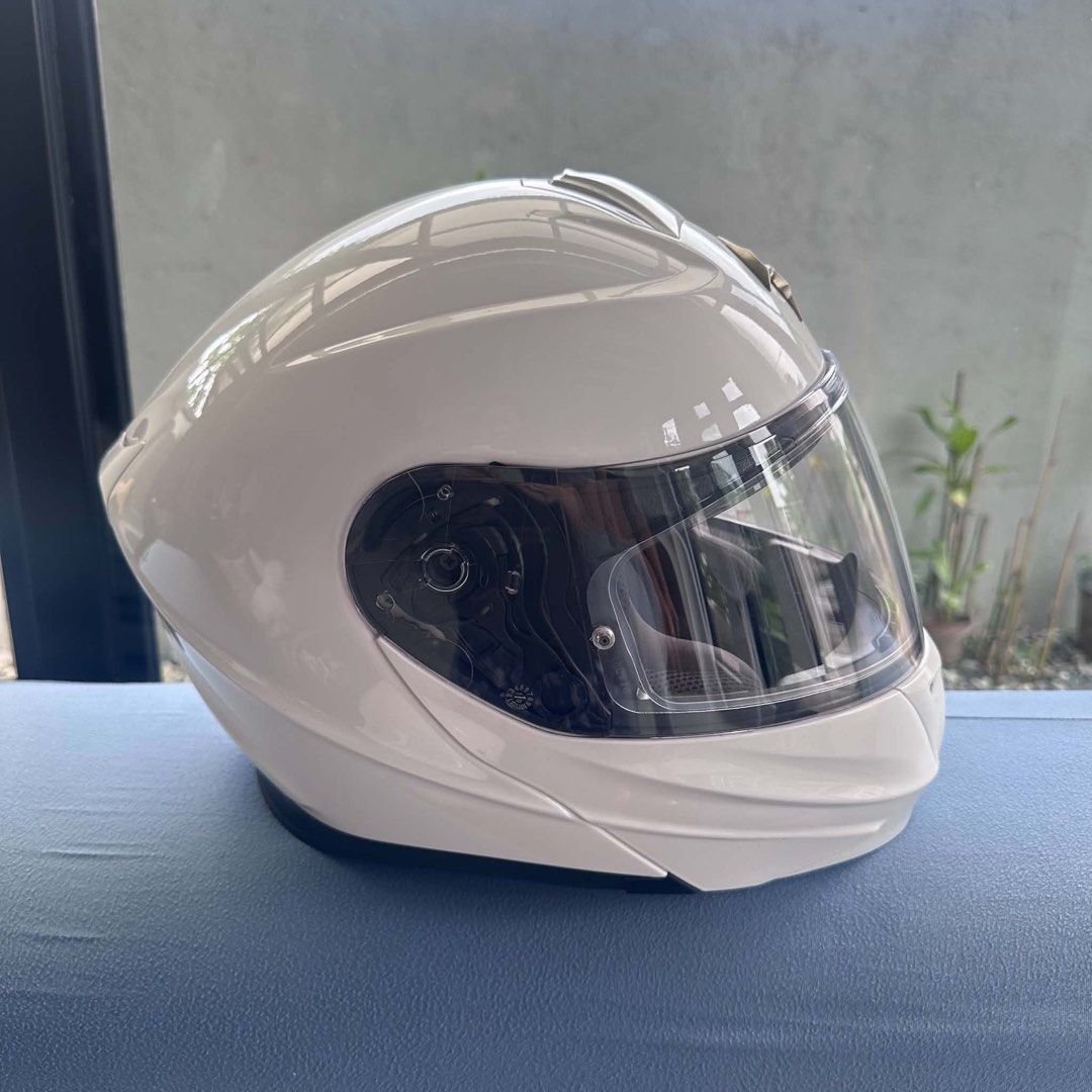 Scorpion EXO modular motorcycle helmet white (Category: Helmets and other Riding Gears) located in Cavite. Submitted by andre.29 (Listing ID 1468742419, Image 2). Description: Solid white modular motorcycle helmet from Scorpion. Flip-up chin bar mechanism works smoothly. Clear main visor plus integrated dark sun visor inside. Top ventilation scoop and front chin vent. Padding inside clean and intact. Clean gloss white finish with minimal signs of
