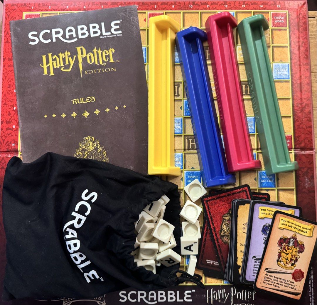 Scrabble Harry Potter Edition Board Game (Category: Board Games & Puzzles) located in San Pedro. Submitted by pageturner19 (Listing ID 1468749292, Image 2). Description: - Official Harry Potter themed Scrabble board game - Includes game board and original box - Complete letter tiles with a black drawstring tile bag - 4 colored tile racks: yellow, blue, pink, and green - Includes Hogwarts cards and rules booklet - Great gift for fans and collector