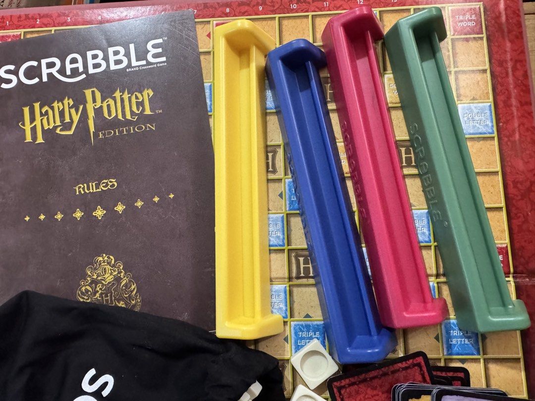 Scrabble Harry Potter Edition Board Game (Category: Board Games & Puzzles) located in San Pedro. Submitted by pageturner19 (Listing ID 1468749292, Image 3). Description: - Official Harry Potter themed Scrabble board game - Includes game board and original box - Complete letter tiles with a black drawstring tile bag - 4 colored tile racks: yellow, blue, pink, and green - Includes Hogwarts cards and rules booklet - Great gift for fans and collector