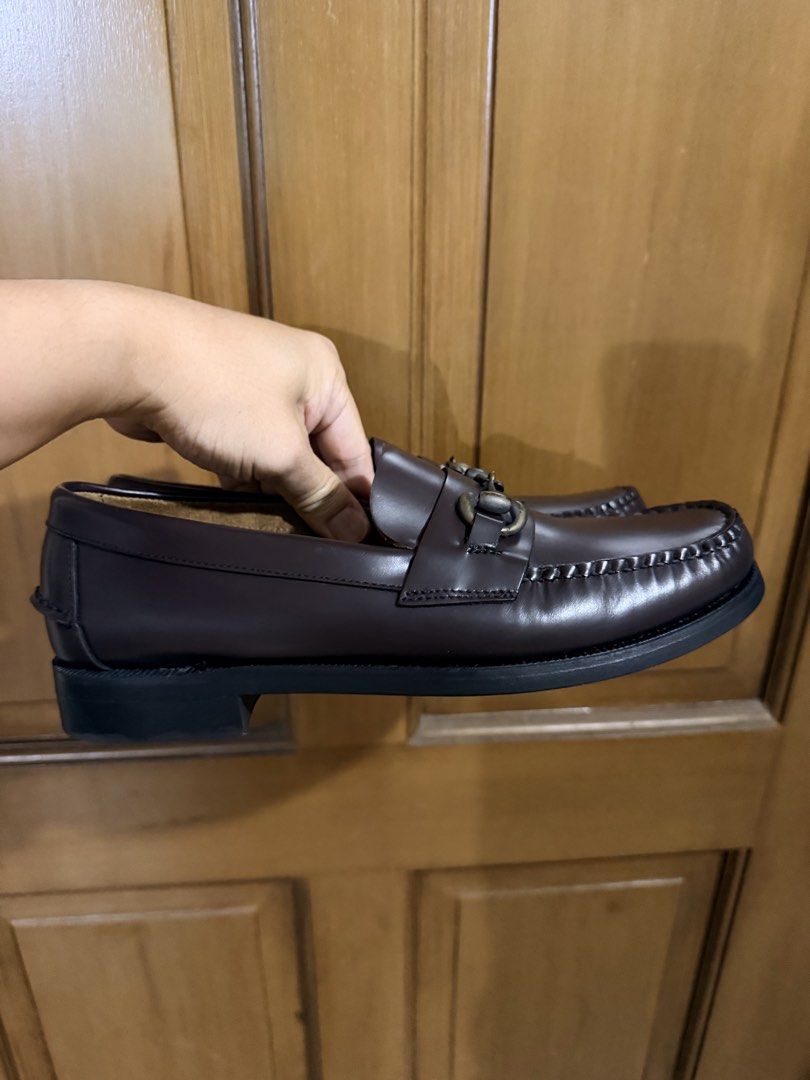 Sebago Loafers Dark Brown (Category: Dress Shoes) located in Pasig City. Submitted by thetravellingguyinstyle (Listing ID 1468789792, Image 3). Description: - Brand: Sebago - Color: Dark brown - Material: Genuine leather - Details: Antique brass horsebit hardware, handsewn construction, moc toe stitching - Condition: Soles and heels intact with minimal wear - Style: Slip-on, versatile for smart casual or formal outfits.