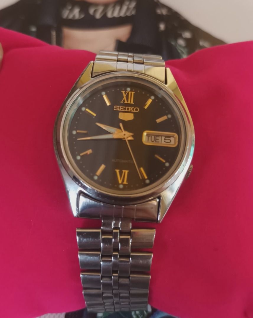 Seiko 5 Automatic Stainless Steel Watch (Category: Men's Watches) located in Pasay City. Submitted by purefox-b7f3 (Listing ID 1468773640, Image 2). Description: - Brand/Model: Vintage Seiko 5 Automatic (please see back ID #) - Movement: Ref. 7009-8031 (Serial: 164817) - Dial: Dark dial with gold-toned markers, Roman numerals at 12 and 6, and a 3 o'clock day-date window - Bracelet: Stainless steel jubilee bracelet with signed folding clasp - Cond