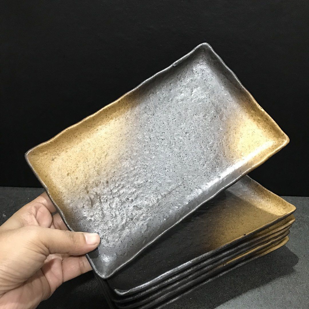 Set of 6 Japanese Ceramic Rectangular Serving Plates (Category: Dinnerware & Cutlery) located in Baao. Submitted by all.things.japan (Listing ID 1468742897, Image 3). Description: 8.75 x 5.5 x 1.0 inches - Set of 6 matching rectangular ceramic plates made from heavy, high-quality stoneware - Stylish textured black surface with gradient brown and yellow tips - Raised edges keep food securely in place - Unglazed rectangular foot ring on the bottom 