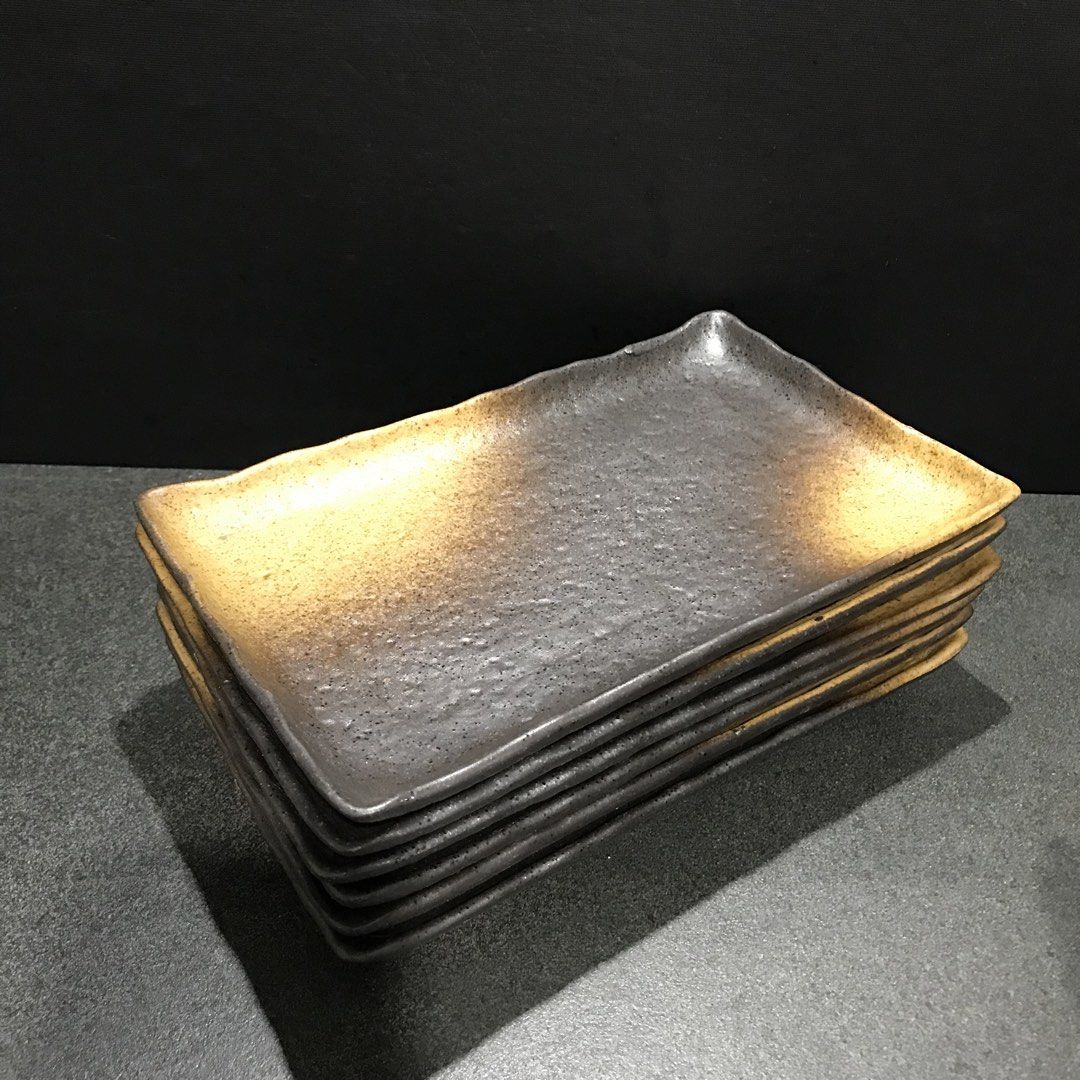 Set of 6 Japanese Ceramic Rectangular Serving Plates (Category: Dinnerware & Cutlery) located in Baao. Submitted by all.things.japan (Listing ID 1468742897, Image 2). Description: 8.75 x 5.5 x 1.0 inches - Set of 6 matching rectangular ceramic plates made from heavy, high-quality stoneware - Stylish textured black surface with gradient brown and yellow tips - Raised edges keep food securely in place - Unglazed rectangular foot ring on the bottom 