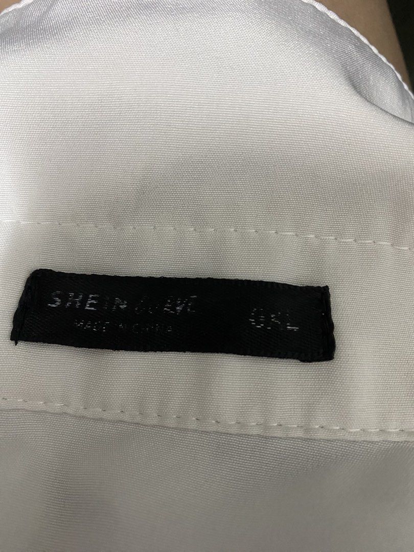 SHEIN Curve White Button Down Shirt OXL (Category: Blouses) located in Taytay. Submitted by themissmj (Listing ID 1468902420, Image 2). Description: - Brand/Size: SHEIN Curve, Tagged size OXL - Style: Casual oversized white button-down shirt - Features: Short sleeves, classic lapel collar, front button closure - Material: Smooth, lightweight woven fabric - Versatility: Neutral solid color, perfect basic wardrobe staple.