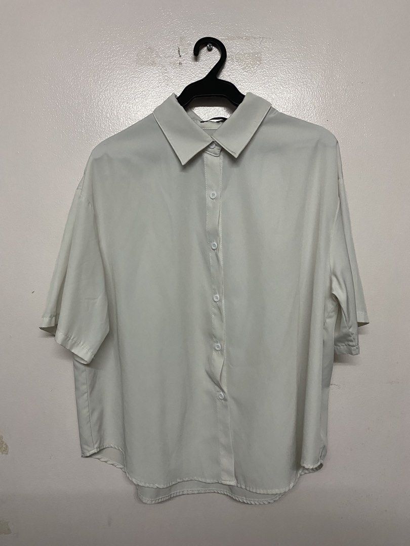 SHEIN Curve White Button Down Shirt OXL (Category: Blouses) located in Taytay. Submitted by themissmj (Listing ID 1468902420, Image 1). Description: - Brand/Size: SHEIN Curve, Tagged size OXL - Style: Casual oversized white button-down shirt - Features: Short sleeves, classic lapel collar, front button closure - Material: Smooth, lightweight woven fabric - Versatility: Neutral solid color, perfect basic wardrobe staple.
