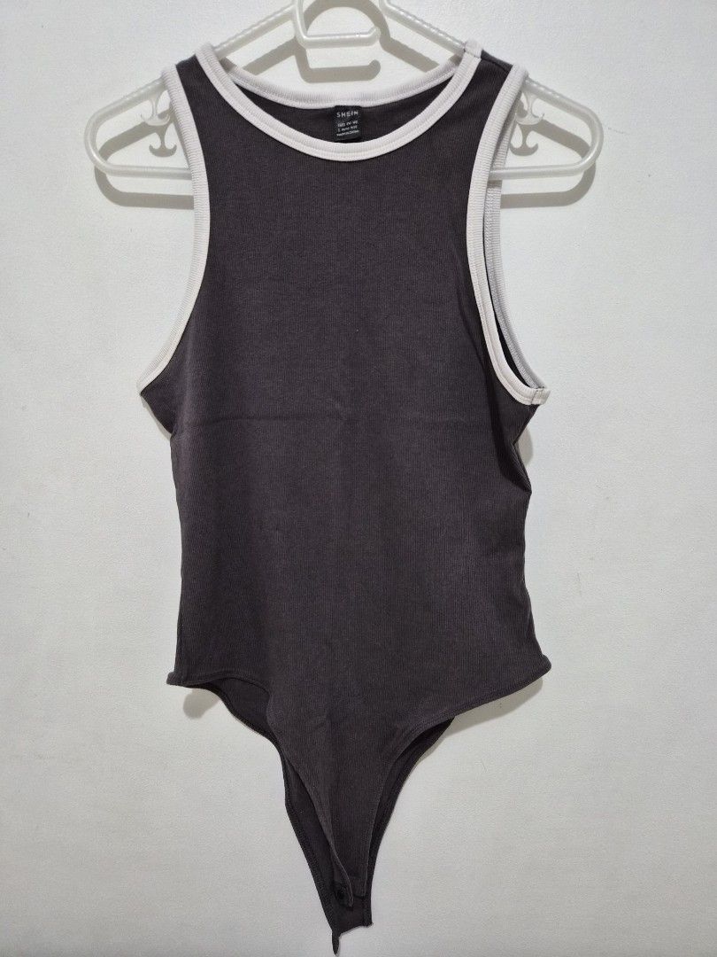 SHEIN Ribbed Contrast Binding Bodysuit (Category: Sleeveless) located in Mandaluyong City. Submitted by joyce1593 (Listing ID 1468818314, Image 1). Description: - Brand: SHEIN - Size: L (fit M) - Color: Dark grey with white contrast binding - Style: Sleeveless tank scoop neck bodysuit with bottom snap closures - Material: Stretchy, super comfortable ribbed fabric.