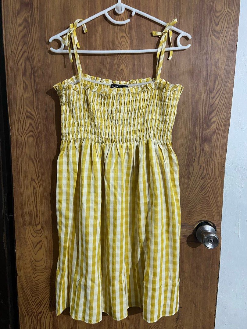 Shein Yellow Gingham Shirred Sundress (Category: Dresses) located in Caloocan City. Submitted by lovedbyryu (Listing ID 1468842941, Image 1). Description: - Brand: Shein - Style: Yellow & white gingham midi dress - Size: L (EU 40/42, US 8/10) - Details: Stretchy smocked bodice, ruffled neckline, and adjustable tie shoulder straps - Material: Lightweight fabric - Condition: Great for warm weather or casual days out.