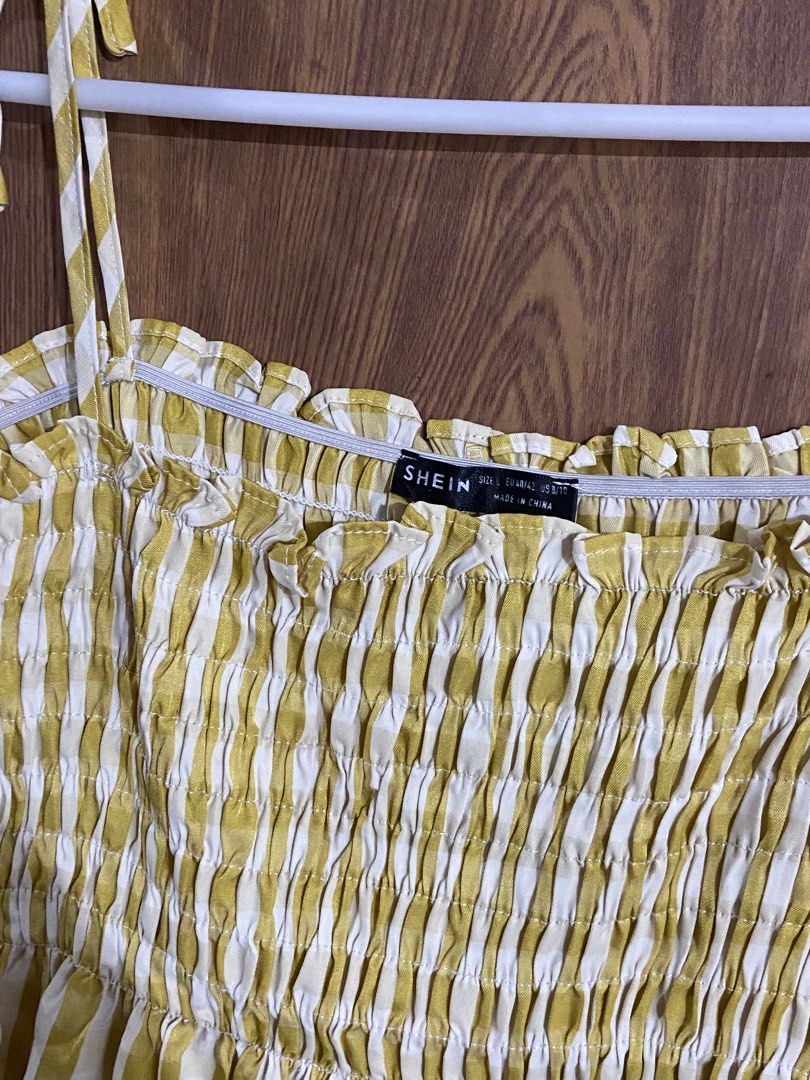 Shein Yellow Gingham Shirred Sundress (Category: Dresses) located in Caloocan City. Submitted by lovedbyryu (Listing ID 1468842941, Image 2). Description: - Brand: Shein - Style: Yellow & white gingham midi dress - Size: L (EU 40/42, US 8/10) - Details: Stretchy smocked bodice, ruffled neckline, and adjustable tie shoulder straps - Material: Lightweight fabric - Condition: Great for warm weather or casual days out.