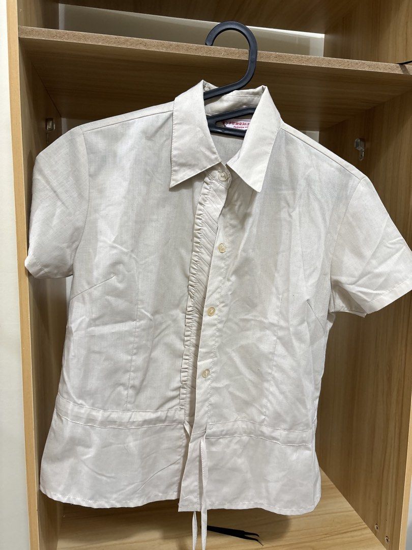 Short sleeve button up shirt cream (Category: Shirts) located in Manila. Submitted by krinpet (Listing ID 1468856592, Image 1). Description: Cream short sleeve button-up shirt in a lightweight, linen-like fabric. Features a pleated front panel, thin hem drawstrings, classic collar, and a fitted cut with front and back darts. A versatile neutral piece that easily matches any outfit..