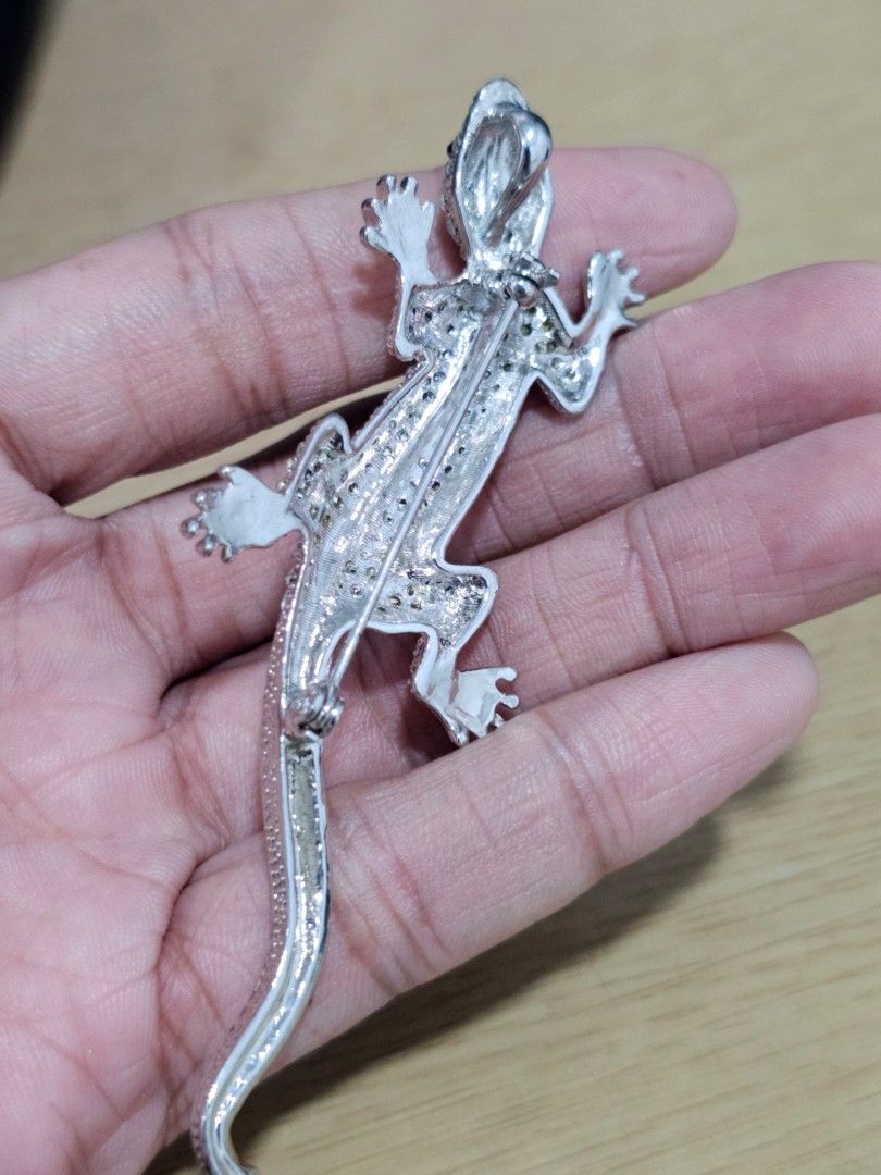 Silver and Black Gecko Lizard Rhinestone Brooch Pin (Category: Brooches) located in Caloocan City. Submitted by smart_shoppers_ville (Listing ID 1468806699, Image 3). Description: - Dual-purpose design: works as both a brooch pin and a pendant necklace charm - Eye-catching silver-tone metal with glittering rhinestones and a bold black stripe - Features detailed feet and a textured body for a realistic look - Decent size that stands out perfectly 