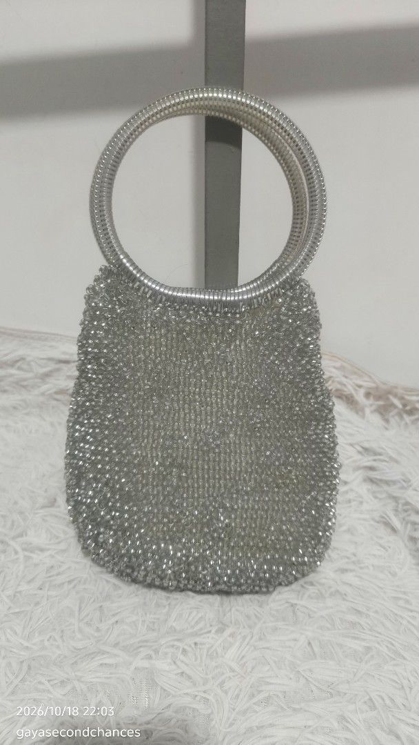 SILVER WIRE BAG (Category: Shoulder Bags) located in Kalibo. Submitted by secondchances.thriftsh8p (Listing ID 1468889699, Image 2). Description: - Color/Finish: Stunning silver with all-over glittering texture - Handles: Sturdy double ring metal handles for easy grip - Design: Small, structured body ideal for parties and evening events - Condition: Clean overall with no loose beads spotted.