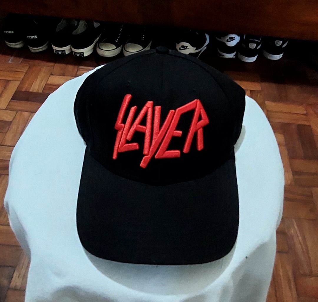 Slayer Black Cap with Red Embroidery (Category: Caps & Hats) located in Legazpi City. Submitted by street_uniform (Listing ID 1468776619, Image 2). Description: - Style: Classic six-panel baseball cap - Design: Bold red embroidered Slayer logo on the front - Color: Solid black with matching brim - Comfort: Embroidered eyelets for breathability - Fit: Adjustable snapback closure for a custom fit - Condition: Brand new / Excellent quality .