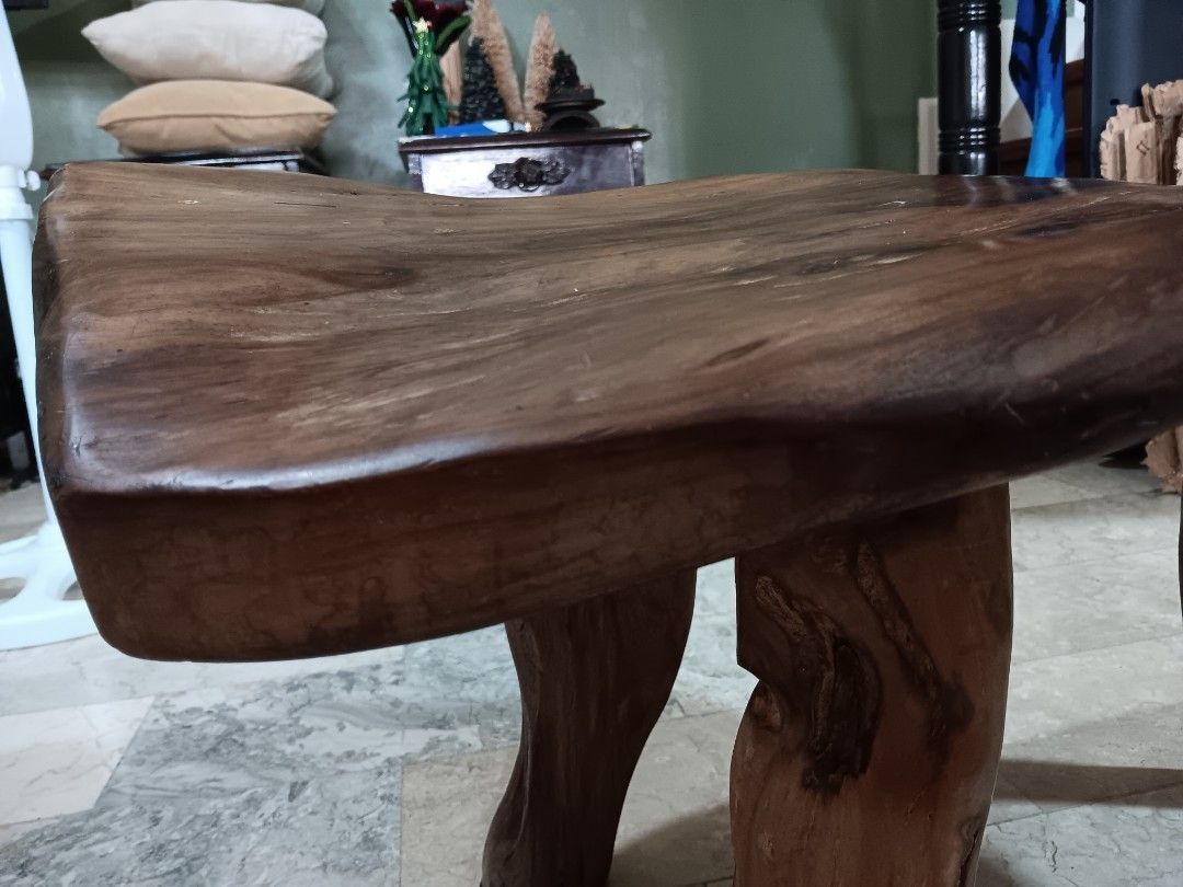 Solid wood live edge bench or coffee table (Category: Chairs) located in Las Pinas. Submitted by jesus1smysavi0r (Listing ID 1468730589, Image 2). Description: - Material: Solid wood with rich brown finish - Design: Unique live edge top with organic branch legs - Structure: Sturdy three-leg design - Finish: Smooth polished surface showing natural contours and knots - Versatility: Perfect rustic accent piece for any room in the house.