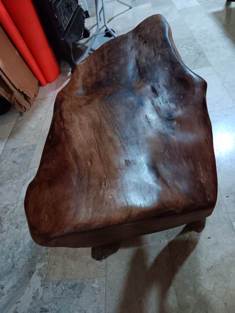Solid wood live edge bench or coffee table (Category: Chairs) located in Las Pinas. Submitted by jesus1smysavi0r (Listing ID 1468730589, Image 3). Description: - Material: Solid wood with rich brown finish - Design: Unique live edge top with organic branch legs - Structure: Sturdy three-leg design - Finish: Smooth polished surface showing natural contours and knots - Versatility: Perfect rustic accent piece for any room in the house.