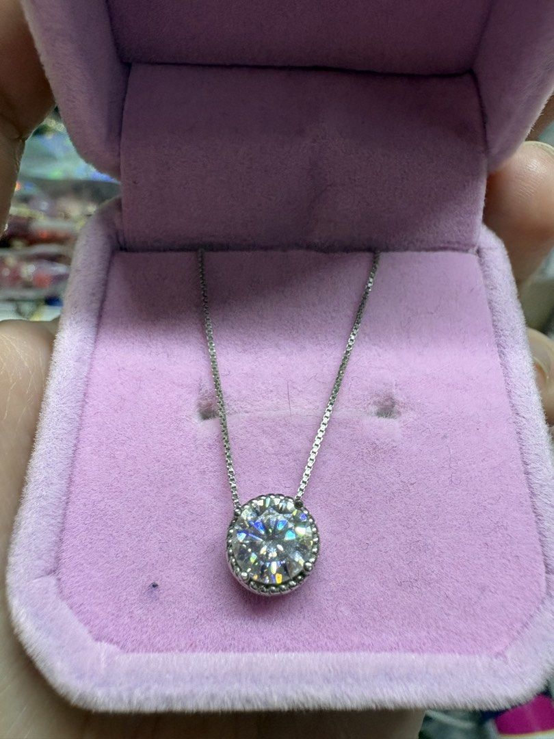 Solitaire Moissanite Pendant Necklace S925 Silver (Category: Necklaces) located in Manila. Submitted by alyannaros79007 (Listing ID 1468898212, Image 2). Description: - Round brilliant-cut solitaire pendant - Delicate silver-tone chain - Secure bezel setting with a beaded rim - Classic, versatile, and perfect for everyday wear - 1 carat Moissanite stone.