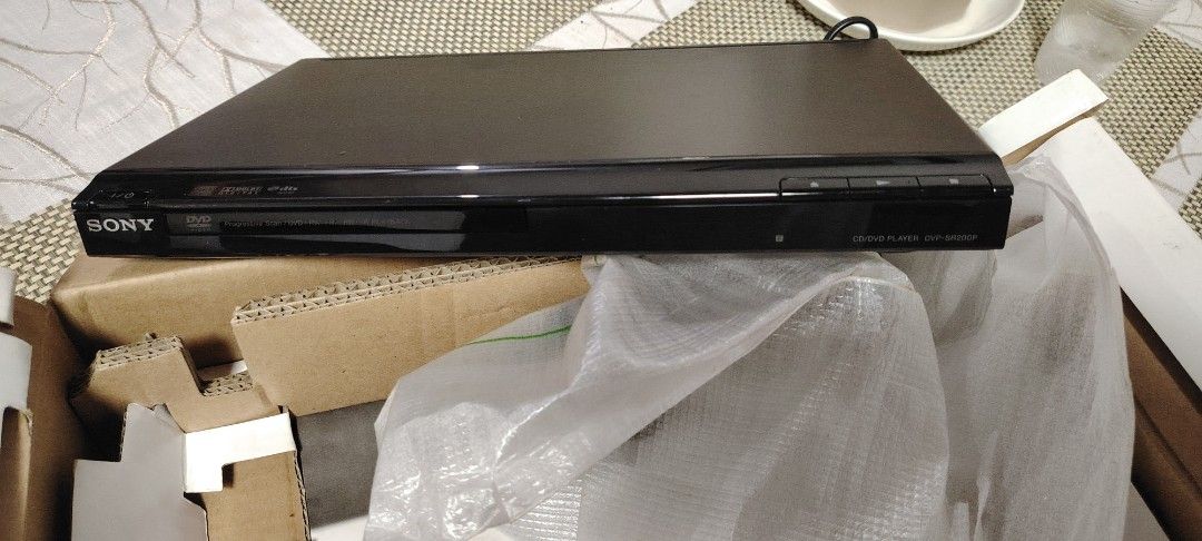 Sony DVP-SR200P CD DVD Player with Remote Control (Category: Blu-Ray & Media Players) located in Manila. Submitted by nikiminmin19779 (Listing ID 1468879208, Image 3). Description: - Model: Sony DVP-SR200P CD DVD Player - Condition: Tested working, excellent shape - Includes: Original remote control, power cable, and plug adapter - Packaging: Still in original plastic wrap and cardboard box - Design: Clean black finish, great compact size for any