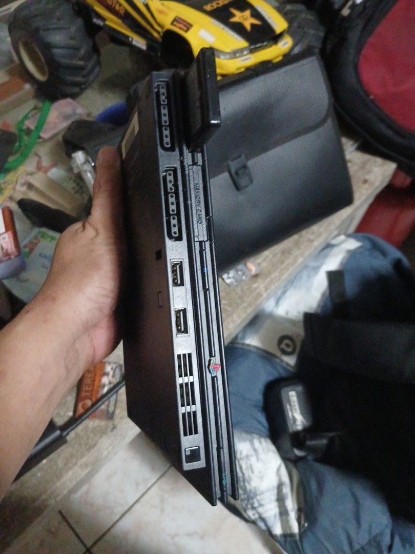 Sony PlayStation 2 Slim Console (Category: PlayStation) located in Manila. Submitted by jakenarvaez0824 (Listing ID 1468849891, Image 3). Description: - Authentic Sony PlayStation 2 Slim console in classic black - Tested and powers on fine, ready for retro gaming - Features front controller ports, memory card slot, and USB ports - Comes with a memory card included in the left slot - Body shows normal scuffs and dust due to storage.