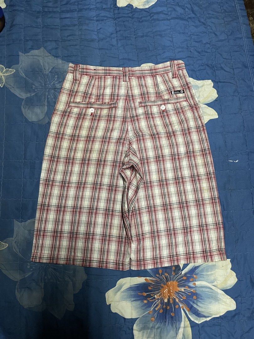 Southpole Red Plaid Shorts (Category: Shorts) located in Manila. Submitted by chawmichael (Listing ID 1468880115, Image 2). Description: - Brand: Southpole - Design: Red, white, and black plaid pattern - Fit: Classic knee-length with belt loops - Pockets: Front slash pockets and button-closure back pockets - Details: Branded label on the inside waistband and back pocket - Material: Comfortable cotton fabric - Style: Casual streetwear.