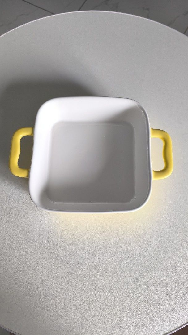 Square ceramic baking dish with yellow handles (Category: Bakeware) located in Manila. Submitted by tinebellen (Listing ID 1468743286, Image 1). Description: - Type: Square baking dish - Color: White with bright yellow handles - Material: Thick ceramic - Ideal for: Small casseroles or single servings - Condition: Used a couple of times, still in great shape (no chips or cracks) - Features: Handy side handles for safe and easy oven removal Japan S