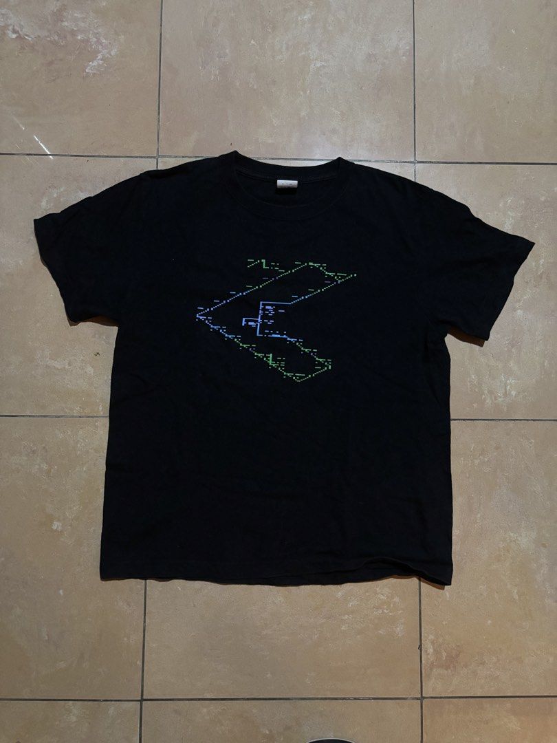 Squarepusher Vortrack JP Promo T-shirt (Category: Tshirts & Polo Shirts ) located in Las Pinas. Submitted by nateb. (Listing ID 1468847397, Image 1). Description: - Color: Black - Design: Blue and green pixelated cyber graphic on chest with large digital matrix print on the back - Fit: Regular fit, comfortable cotton fabric - Measurements: ~25 inches length, ~20 inches armpit to armpit - Condition: Clean, well-maintained pre-loved item.