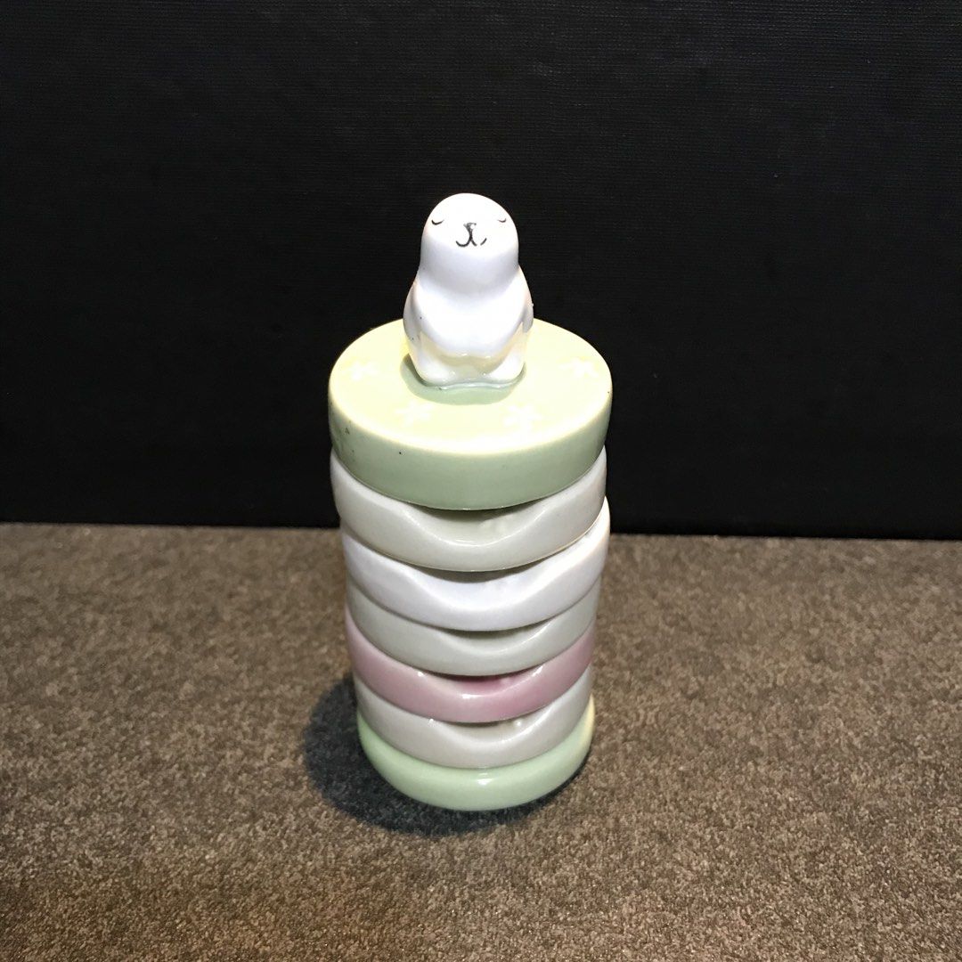 Stackable Napkin Rings Tower with Cute Animal Topper (Category: Other Kitchenware & Tableware) located in Baao. Submitted by all.things.japan (Listing ID 1468750060, Image 1). Description: 1.75 inches diameter - Ceramic ring holder set in mint, white, and pink pastel tones - Features a cute white animal figure on the top tier - Vertical stand post for easy stacking and organization - Ideal for vanities, dressers, or bedside tables - Condition: Ve