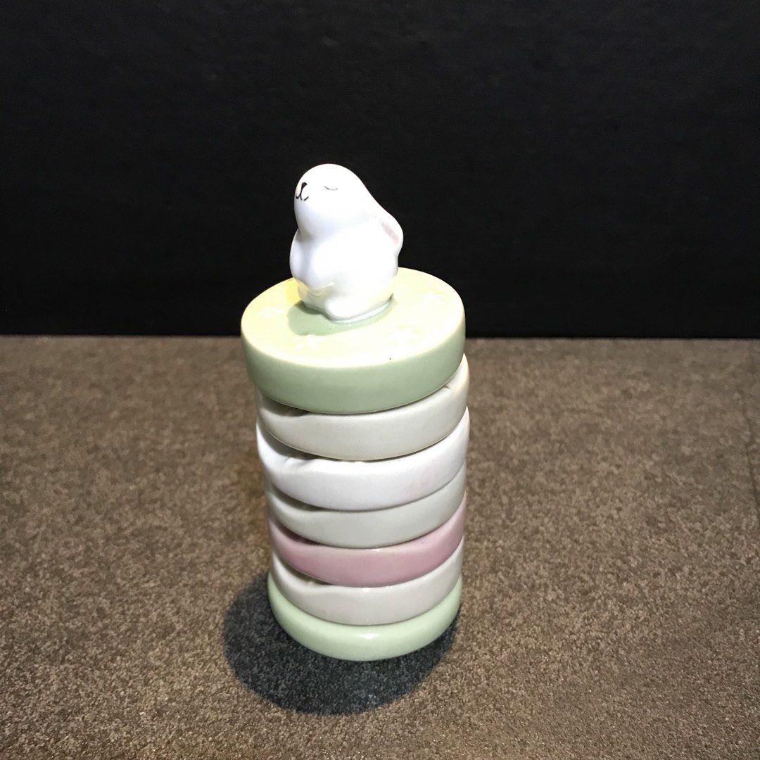 Stackable Napkin Rings Tower with Cute Animal Topper (Category: Other Kitchenware & Tableware) located in Baao. Submitted by all.things.japan (Listing ID 1468750060, Image 2). Description: 1.75 inches diameter - Ceramic ring holder set in mint, white, and pink pastel tones - Features a cute white animal figure on the top tier - Vertical stand post for easy stacking and organization - Ideal for vanities, dressers, or bedside tables - Condition: Ve