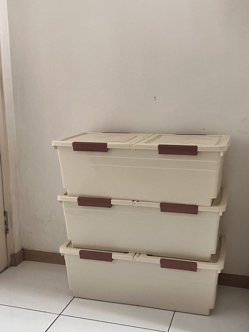 Stackable plastic storage boxes with lids (Category: Storage Boxes & Baskets) located in Shah Alam. Submitted by atiraasalleh (Listing ID 1468756685, Image 1). Description: - Set of 3 sturdy beige plastic storage boxes - Secure brown latch clips on both ends of the lids - Rectangular design ideal for closets, garages, or bedrooms - Sold as a complete set of three.