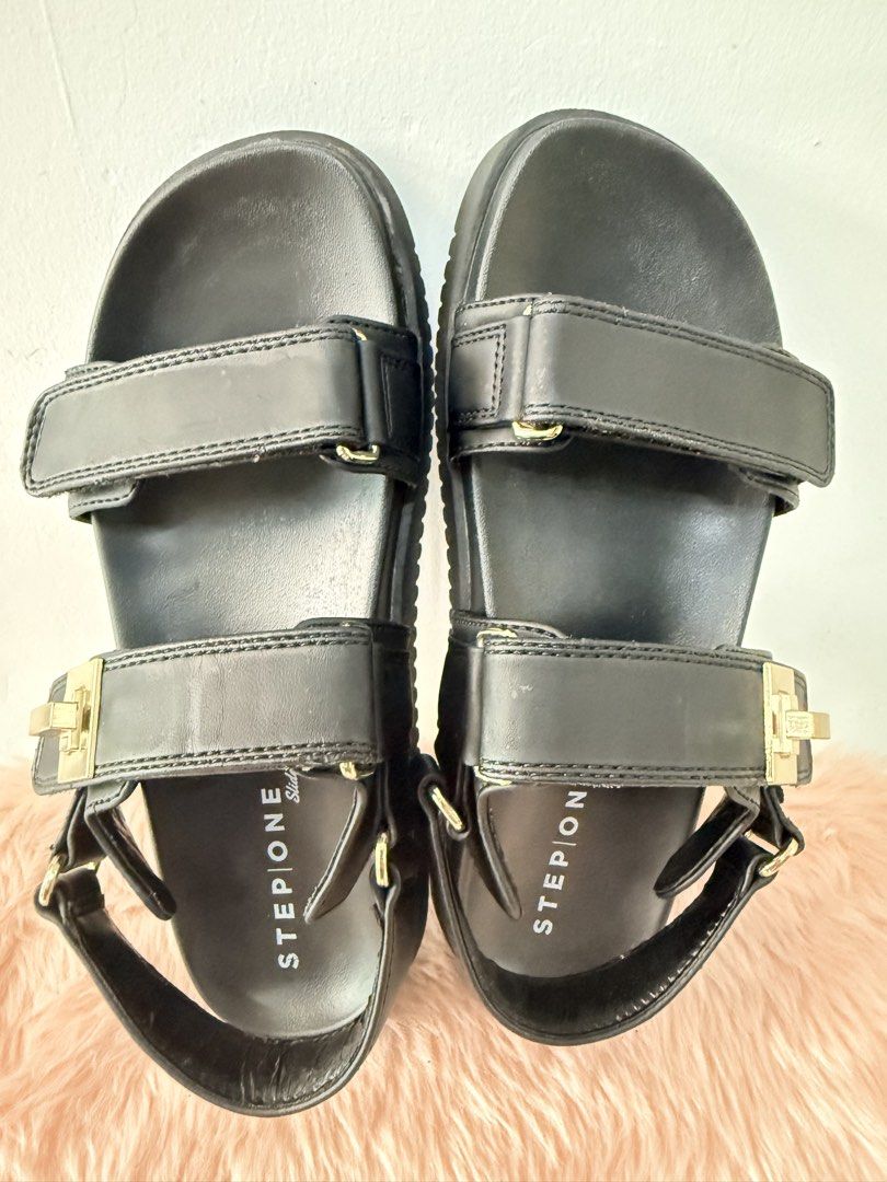 Stepone Slide Black Sandals Size 7 (Category: Flats & Sandals) located in Quezon City. Submitted by shaberbree (Listing ID 1468737660, Image 3). Description: - Brand: Stepone - Color: Black - Size: US 7 - Style: Chunky platform slide sandals with gold-tone hardware accents - Fit: Adjustable velcro straps on top and back heel - Traction: Textured rubber soles for anti-slip grip - Condition: Clean footbeds with clear branding, minor wear on bottom 