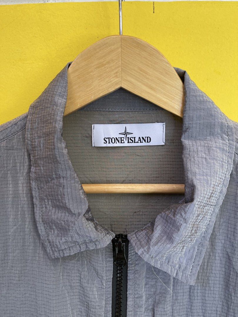 Stone Island Grid Check Zip Jacket Grey Size M (Category: Coats, Jackets and Outerwear) located in Baguio. Submitted by yuno.cartel (Listing ID 1468728341, Image 2). Description: - Authentic Stone Island jacket in grey - Unique grid pattern texture throughout - Size: Large fitting - Full zip closure with collar - Dual chest flap pockets - Signature compass patch badge on left sleeve - Verified genuine via interior Certilogo tag - Condition: Excel