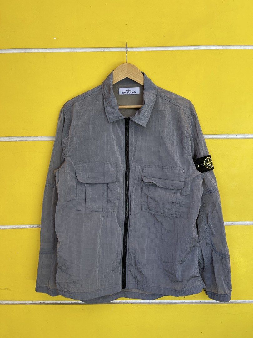 Stone Island Grid Check Zip Jacket Grey Size M (Category: Coats, Jackets and Outerwear) located in Baguio. Submitted by yuno.cartel (Listing ID 1468728341, Image 1). Description: - Authentic Stone Island jacket in grey - Unique grid pattern texture throughout - Size: Large fitting - Full zip closure with collar - Dual chest flap pockets - Signature compass patch badge on left sleeve - Verified genuine via interior Certilogo tag - Condition: Excel