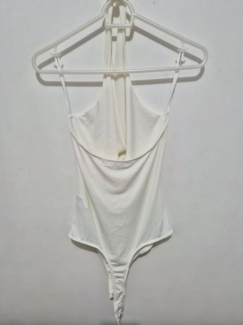 Stradivarius White Cowl Neck Bodysuit Size M (Category: Sleeveless) located in Mandaluyong City. Submitted by joyce1593 (Listing ID 1468818492, Image 3). Description: - Brand: Stradivarius - Item: Cowl neck bodysuit - Color: White - Size: M (EUR M, USA M, MEX 28) - Origin: Made in Turkey - Design: Sleeveless with thin straps and bottom snap button closure - Styling: Perfect basic piece for layering or wearing on its own.