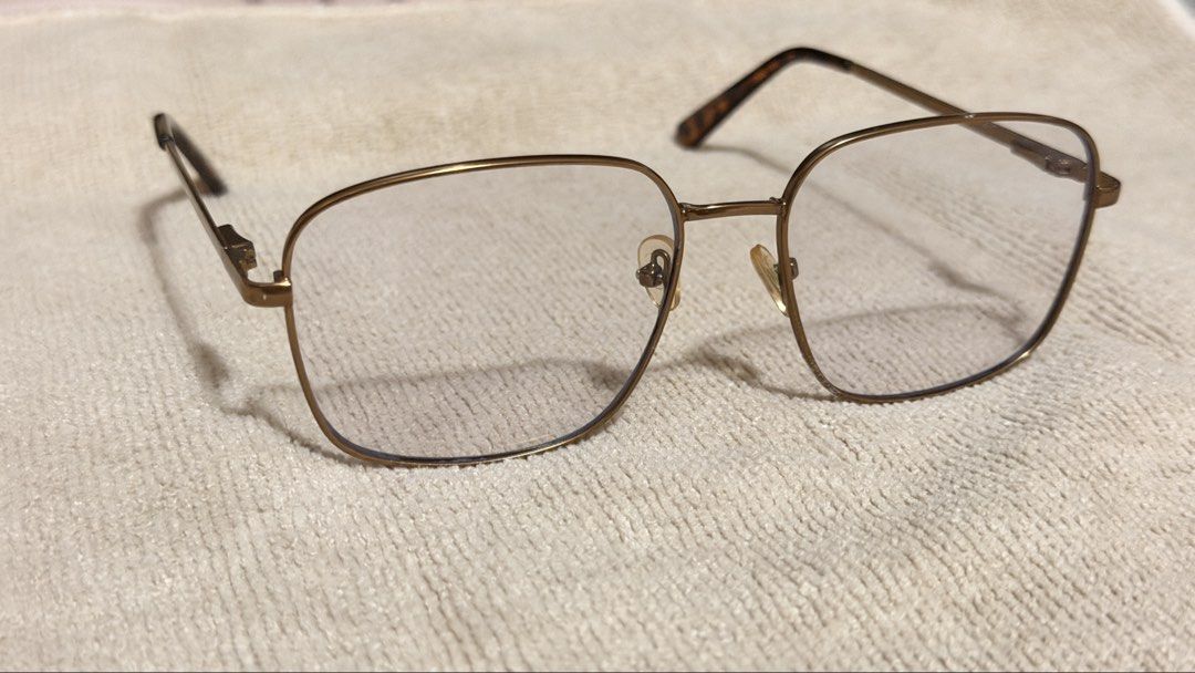 SUNNIES ANTI RAD GLASSES (Category: Sunglasses & Eyewear) located in General Santos City (Dadiangas). Submitted by ccaburog (Listing ID 1468884040, Image 2). Description: - Frame: Gold-tone metal in a trendy square silhouette - Details: Tortoiseshell acetate temple tips and clear lenses - Fit: Lightweight everyday style, standard adult sizing - Condition: Adjustable nose pads show minor discoloration due to age INCLUSION: Box.