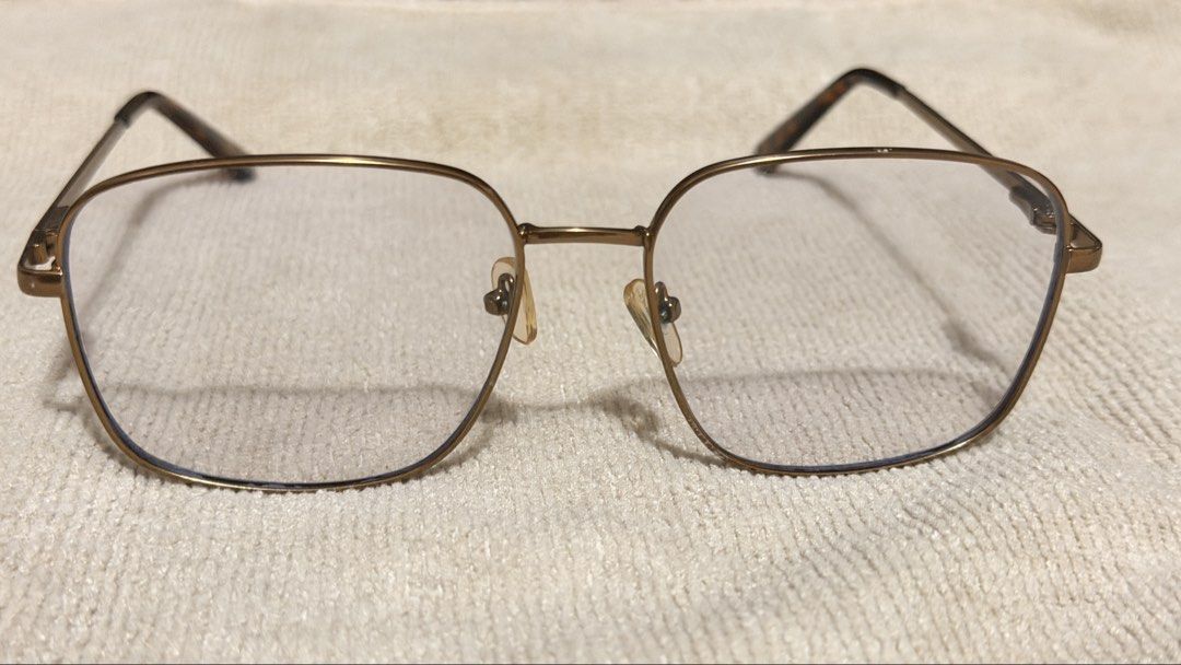 SUNNIES ANTI RAD GLASSES (Category: Sunglasses & Eyewear) located in General Santos City (Dadiangas). Submitted by ccaburog (Listing ID 1468884040, Image 3). Description: - Frame: Gold-tone metal in a trendy square silhouette - Details: Tortoiseshell acetate temple tips and clear lenses - Fit: Lightweight everyday style, standard adult sizing - Condition: Adjustable nose pads show minor discoloration due to age INCLUSION: Box.