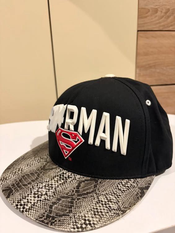Superman DC Comics Snapback Cap Snake Print Brim (Category: Caps & Hats) located in Cebu City. Submitted by ubecstoned (Listing ID 1468821715, Image 2). Description: - Official DC Comics / Warner Bros. merchandise - Color: Black with grey snake print flat brim - Front: Raised white lettering with red Superman logo - Back: DC embroidered logo and adjustable strap with Warner Bros. red tag - Interior: Branded tape and Superman tag, extremely clean 