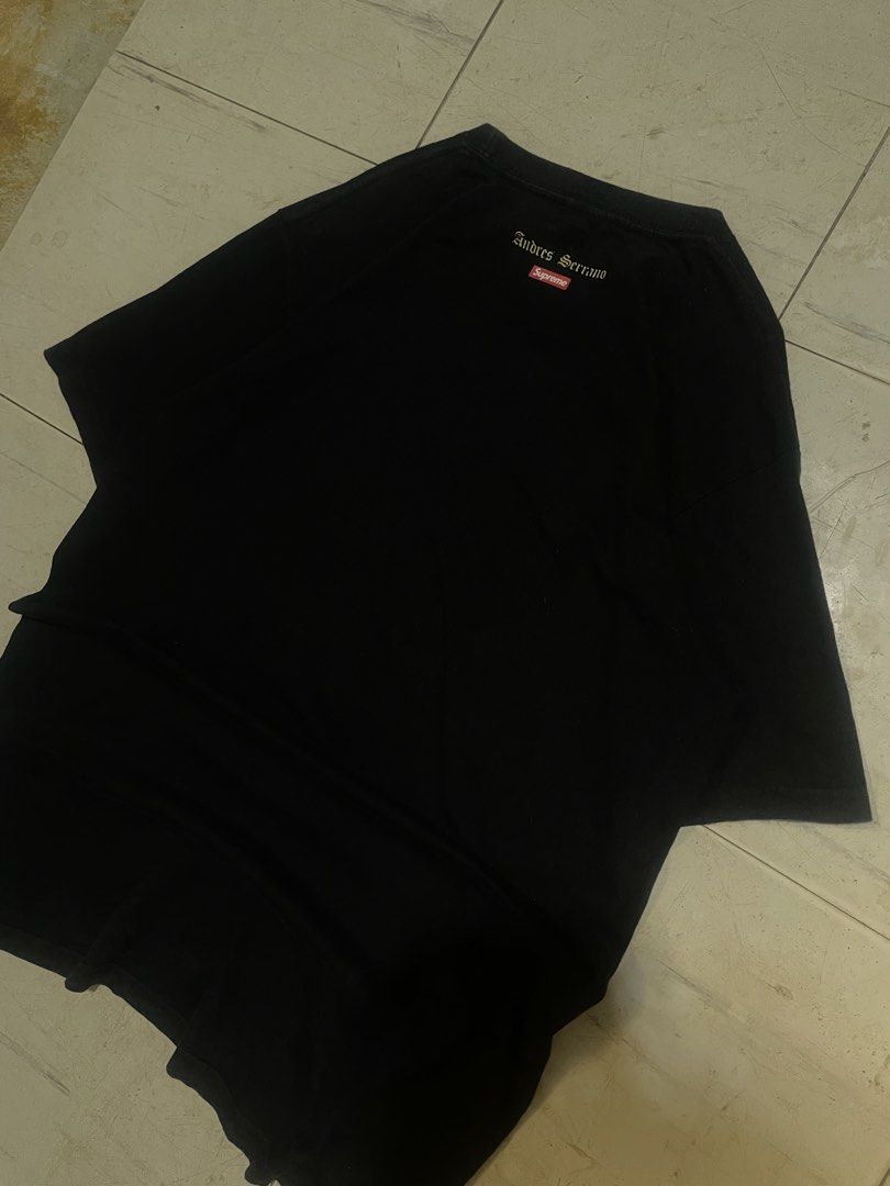 Supreme Andres Serrano Piss Christ Tee Black (Category: Tshirts & Polo Shirts ) located in Famy. Submitted by bravemoon-2c97 (Listing ID 1468761498, Image 3). Description: - Brand: Supreme - Style: Andres Serrano Piss Christ Graphic Tee - Color: Black - Size: Medium - Material: 100% Cotton, Made in USA - Details: Iconic chest graphic with back mini box logo and artist text - Condition: Highly collectible streetwear piece.
