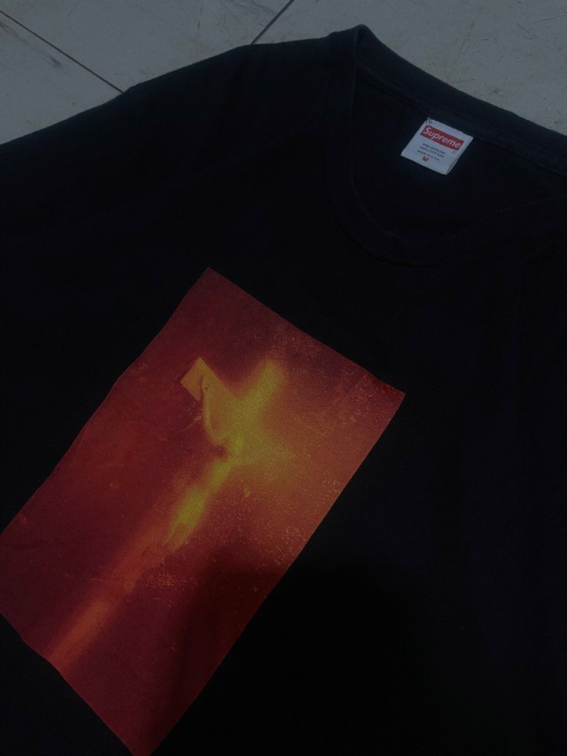 Supreme Andres Serrano Piss Christ Tee Black (Category: Tshirts & Polo Shirts ) located in Famy. Submitted by bravemoon-2c97 (Listing ID 1468761498, Image 2). Description: - Brand: Supreme - Style: Andres Serrano Piss Christ Graphic Tee - Color: Black - Size: Medium - Material: 100% Cotton, Made in USA - Details: Iconic chest graphic with back mini box logo and artist text - Condition: Highly collectible streetwear piece.