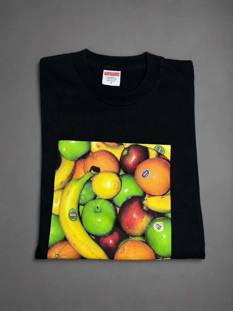 Supreme Fruit Tee Black Size S (Category: Tshirts & Polo Shirts ) located in Urdaneta. Submitted by jayceegarage (Listing ID 1468901224, Image 3). Description: - Brand: Supreme - Color: Black with classic fruit graphic on chest - Size: Small - Material: 100% cotton, Made in U.S.A. - Details: Red box logo tag on inner collar, care label with RN number on back neck - Condition: Clean, solid graphic print with zero cracks - Perfect addition to any s