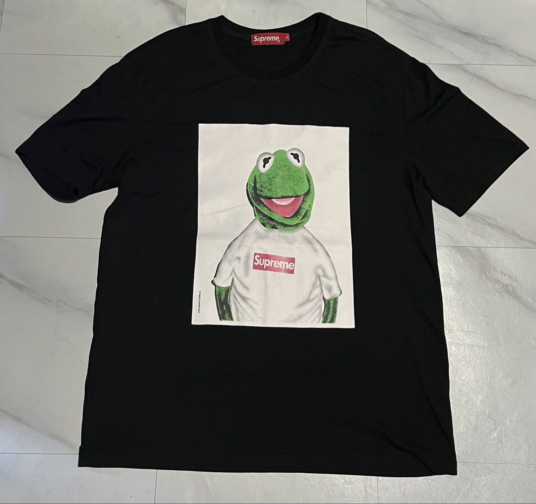 Supreme Kermit the Frog Graphic Tee Black Size L (Category: Tshirts & Polo Shirts ) located in Cavite. Submitted by christianzuuu (Listing ID 1468783230, Image 1). Description: - Legit/ Off for the items - Item: Supreme Kermit the Frog Tee - Color: Black - Size: Large (Measurements: approx. 20" width x 27.5" length) - Details: Iconic front graphic, red Supreme box logo tag at the collar - Material: 64.4% cotton and 35.6% polyester blend - Conditi