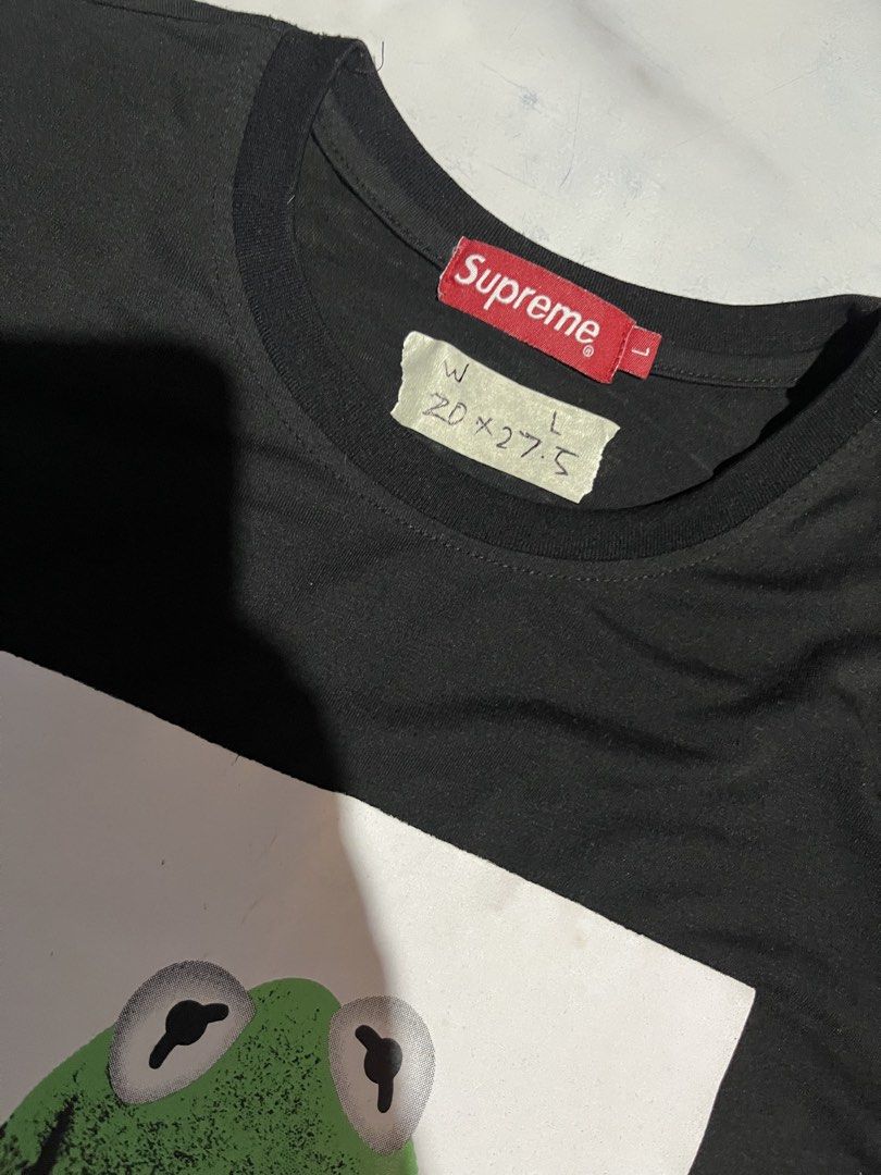 Supreme Kermit the Frog Graphic Tee Black Size L (Category: Tshirts & Polo Shirts ) located in Cavite. Submitted by christianzuuu (Listing ID 1468783230, Image 2). Description: - Legit/ Off for the items - Item: Supreme Kermit the Frog Tee - Color: Black - Size: Large (Measurements: approx. 20" width x 27.5" length) - Details: Iconic front graphic, red Supreme box logo tag at the collar - Material: 64.4% cotton and 35.6% polyester blend - Conditi
